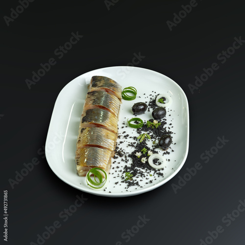 traditional dishes of European cuisine, delicacy, banquet snack. culinary dishes on a white plate on a black background. restaurant service photo