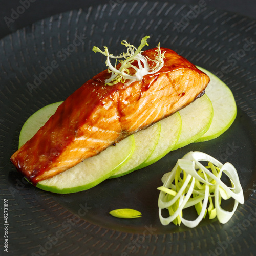 traditional dishes of European cuisine, delicacy, banquet snack. culinary dishes on a white plate on a black background. restaurant service photo