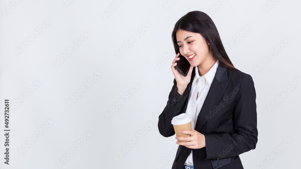 Entrepreneur pretty woman holding coffee cup and touching screen on smart phone mobile on white background, attractive asian people drink beverage smart, Technology communication lifestyles concept. Entrepreneur pretty woman holding coffee cup and touching screen on smart phone mobile on white background, attractive asian people drink beverage smart, Technology communication lifestyles concept.