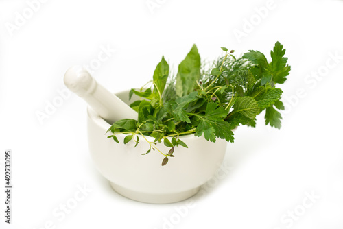 Fresh herbs in mortar and pestle