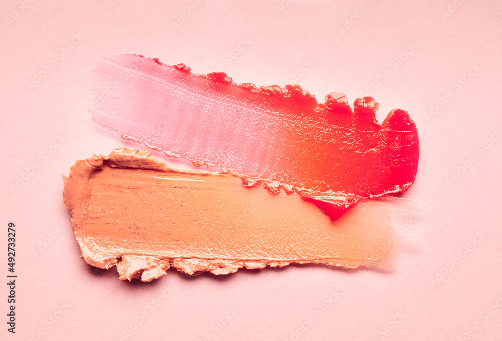 Lipstick burgundy peach orange brown balm lip gloss swatch isolated on beige background - obrazy, fototapety, plakaty 
