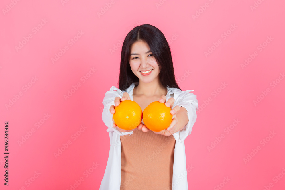 asian young pretty woman happy smile with orange fruit Vitamin C, beauty clean fresh skin, face care, facial treatment, lifestyle and healthy food concept. asian young pretty woman happy smile with orange fruit Vitamin C, beauty clean fresh skin, face care, facial treatment, lifestyle and healthy food concept.