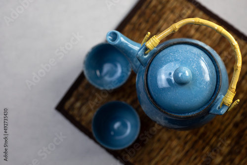 Blue ceramic teapot set on gray background