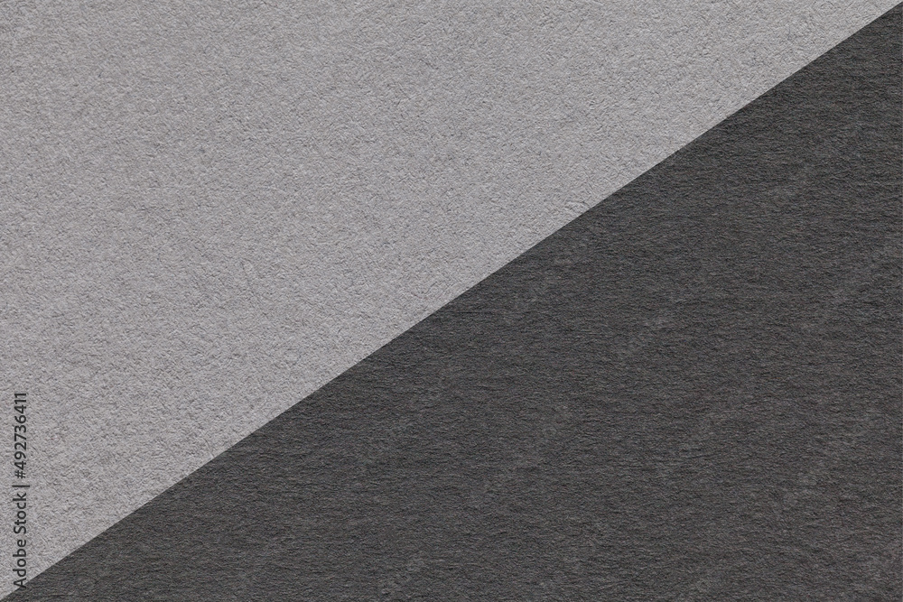Texture of craft gray and black paper background, half two colors, macro. Structure of vintage dense kraft cardboard. Texture of craft gray and black paper background, half two colors, macro. Structure of vintage dense kraft cardboard.
