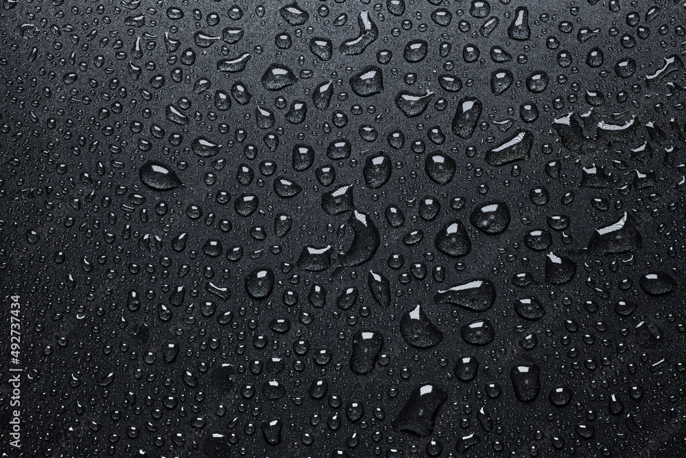 Black teflon texture with water or oil drops Black teflon texture with water or oil drops