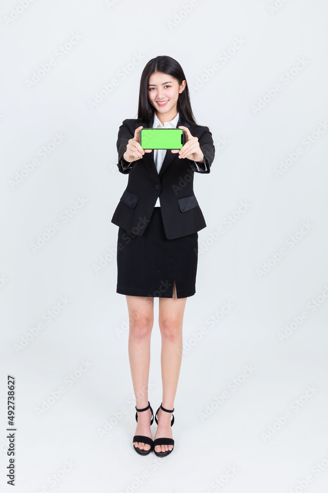 business asian woman wearing office clothing successful hold smart phone mobile and computer laptop , Technology communication lifestyles concept. business asian woman wearing office clothing successful hold smart phone mobile and computer laptop , Technology communication lifestyles concept.