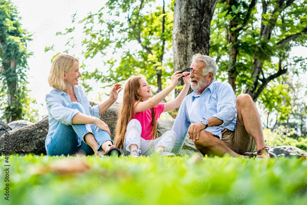 Fototapeta premium Happy family parent and child relax in weekend holiday lifestyle park outdoor nature background.