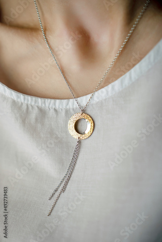 necklace on woman's neck on dark background