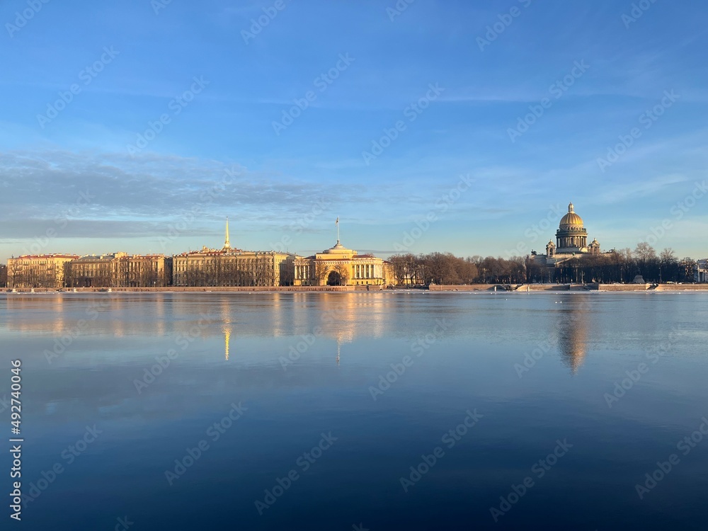 River surface with the reflection of the historical city architecture, blue sky, peaceful 