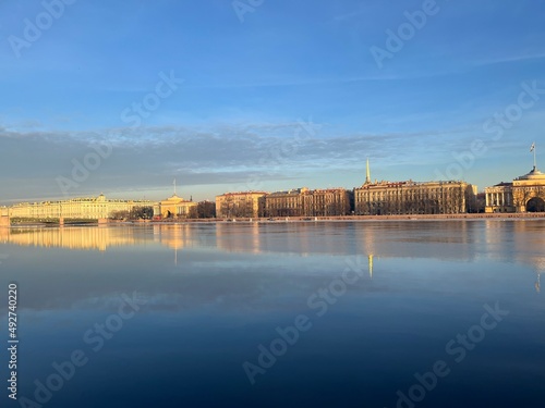 River surface with the reflection of the historical city architecture, blue sky, peaceful 