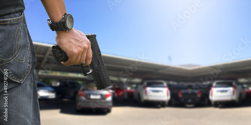 Fotografie 9mm automatic pistol holding in right hand of shooter, concept for security, robbery, gangster, bodyguard around the world