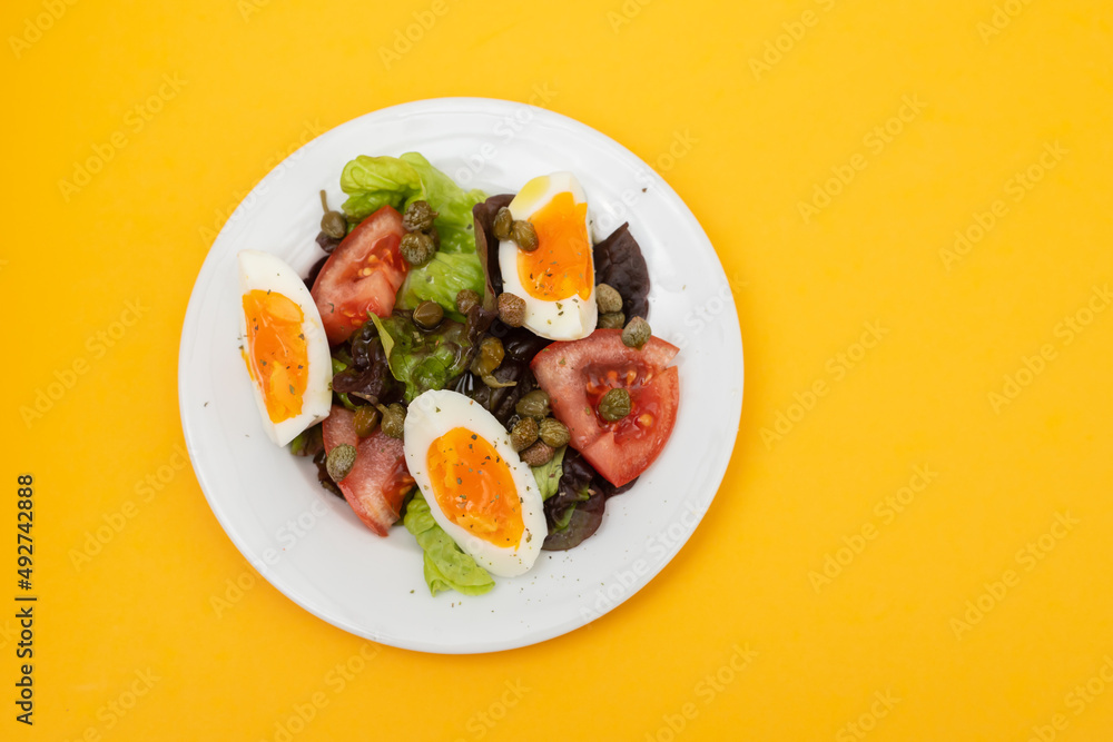 fresh vegetable salad with boiled egg on white dish fresh vegetable salad with boiled egg on white dish