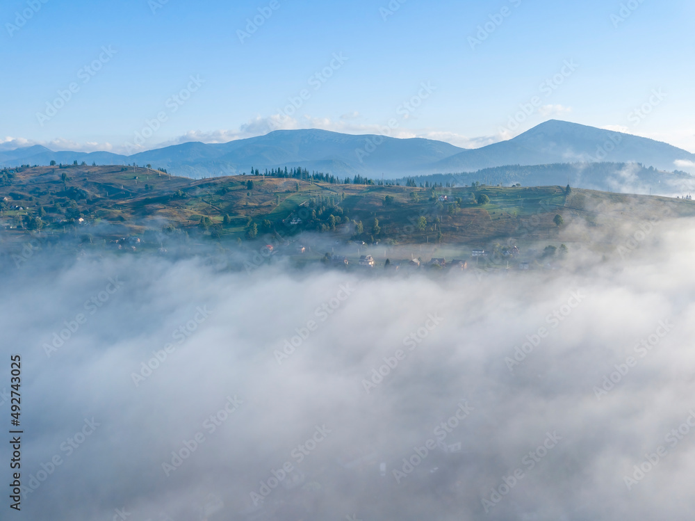 Morning fog in the Ukrainian Carpathians. Aerial drone view.