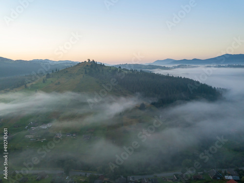 Green mountains of the Ukrainian Carpathians in the morning mist. Aerial drone view. © Sergey