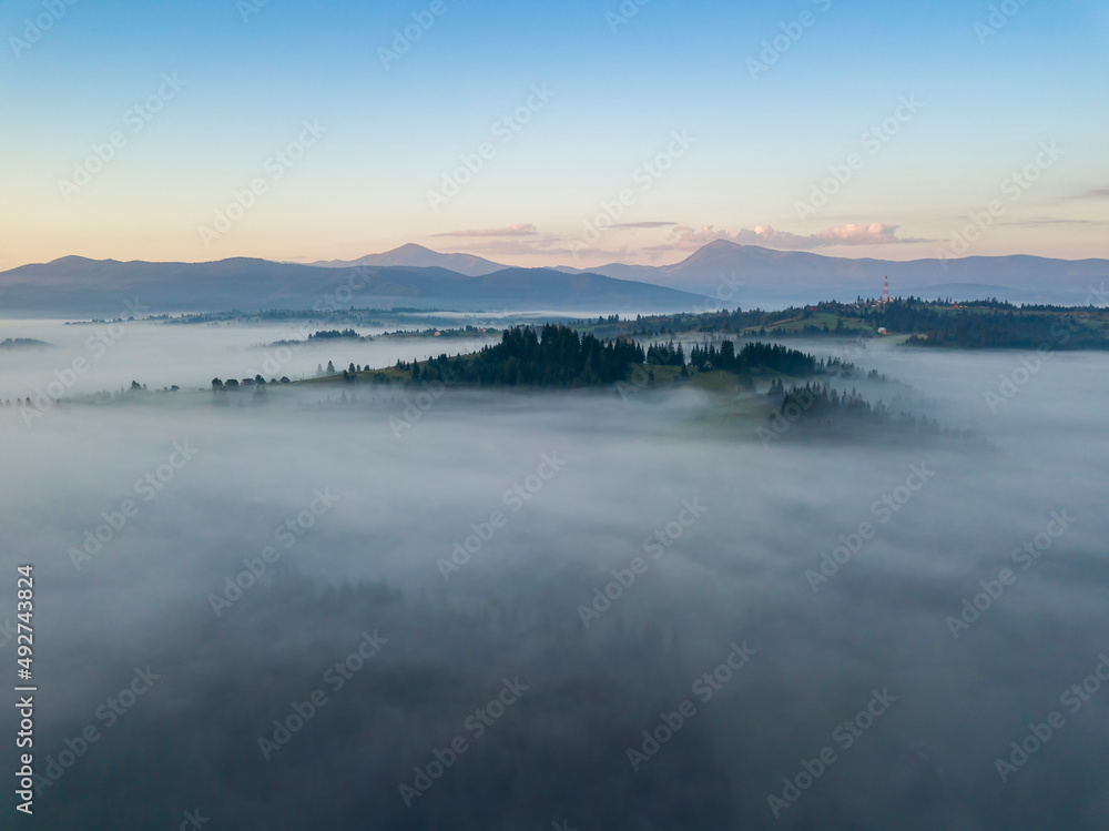 Fototapeta premium Morning fog in the Ukrainian Carpathians. Aerial drone view.