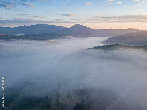 Sunrise over the fog in the Ukrainian Carpathians. Aerial drone view.