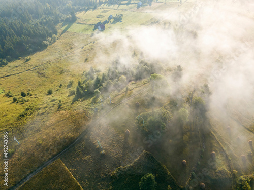 Green mountains of the Ukrainian Carpathians in the morning mist. Aerial drone view. © Sergey