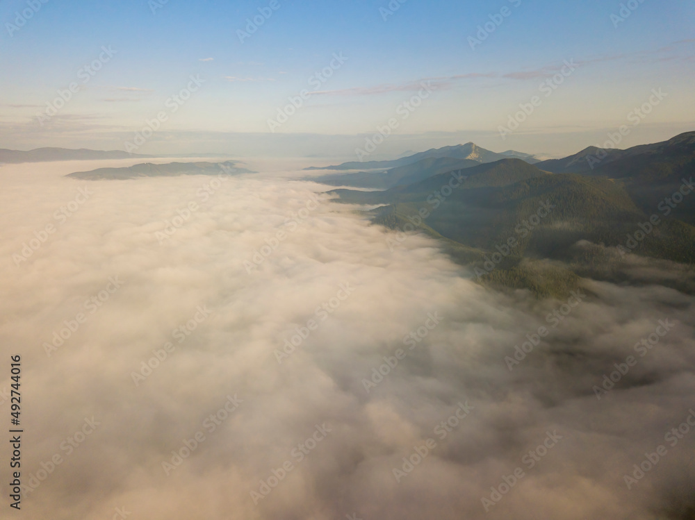 Sunrise over the fog in the Ukrainian Carpathians. Aerial drone view. Sunrise over the fog in the Ukrainian Carpathians. Aerial drone view.