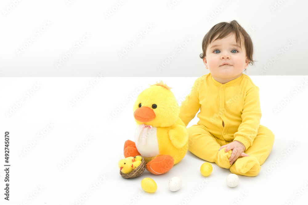 Easter concept with eight months old baby boy sitting on a bed with chickens and Easter eggs. Easter concept with eight months old baby boy sitting on a bed with chickens and Easter eggs.
