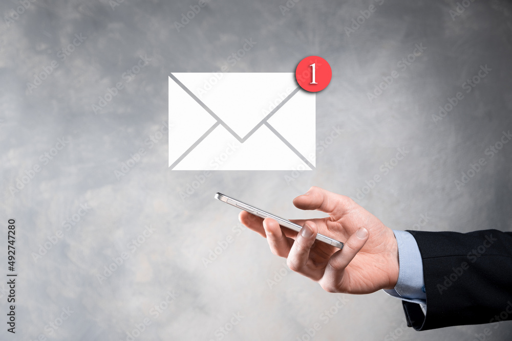 Businessman hand holding e-mail icon, Contact us by newsletter email and protect your personal information from spam mail. Customer service call center contact us concept Businessman hand holding e-mail icon, Contact us by newsletter email and protect your personal information from spam mail. Customer service call center contact us concept