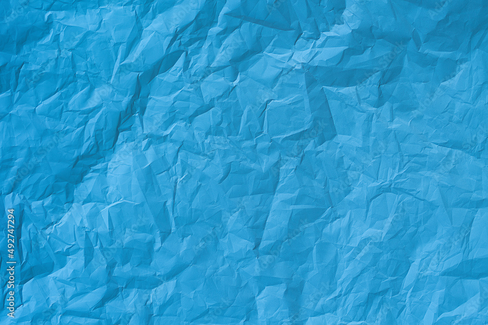 Fototapeta premium Blue crumpled paper texture background. 