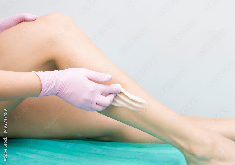 Hair removal in a luxury spa studio. Wax for women's feet with saccharin. Hot sugar. The product is made of a wax bowl. The bank's salon. Hair removal in a luxury spa studio. Wax for women's feet with saccharin. Hot sugar. The product is made of a wax bowl. The bank's salon.