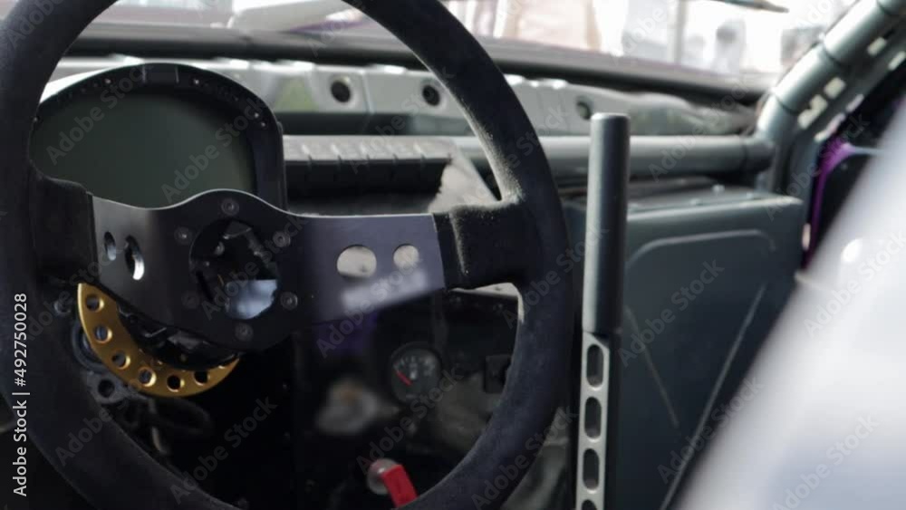 Cabin interior of a modified drift car. Luxury racing sports car. Drift car interior. Focus on the strut, close-up on the wheel and gearshift clutch. Cabin interior of a modified drift car. Luxury racing sports car. Drift car interior. Focus on the strut, close-up on the wheel and gearshift clutch.