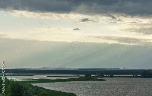Wallpaper Mural Landscape with silver sunny rays from gray clouds on the water surface of the Sviyaga River around Sviyazhsk. Picturesque landscape of Russian nature near the town-island of Sviyazhsk Torontodigital.ca