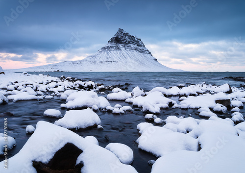 Kirkjufell mountain, Iceland. Winter landscape. The mountain and the ocean. S...