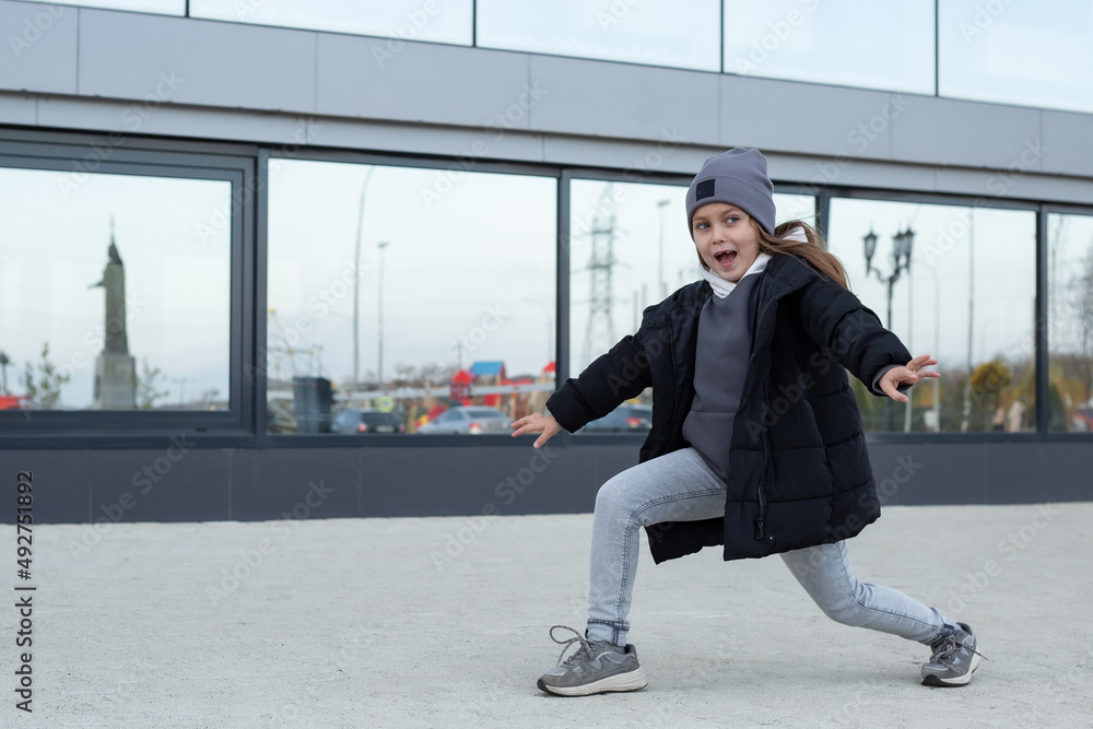 cute girl laughs and walks in broad strides