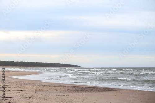 Shore seaside cloudy view with sand and baltic sea.