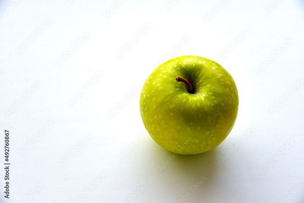 A delicious green apple on a white background A delicious green apple on a white background