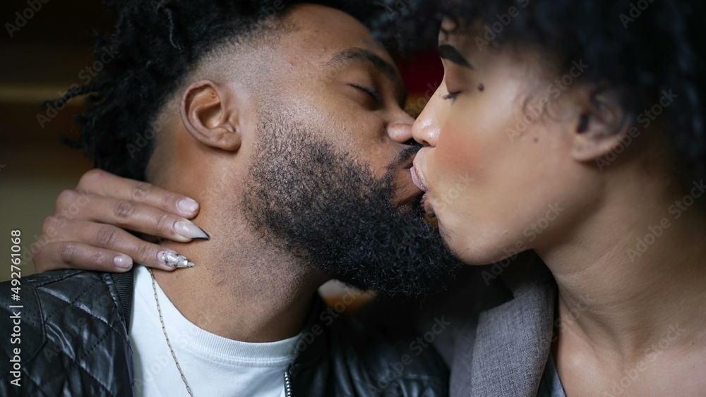 Passionate kiss a black couple kissing an African man and woman love Passionate kiss a black couple kissing an African man and woman love
