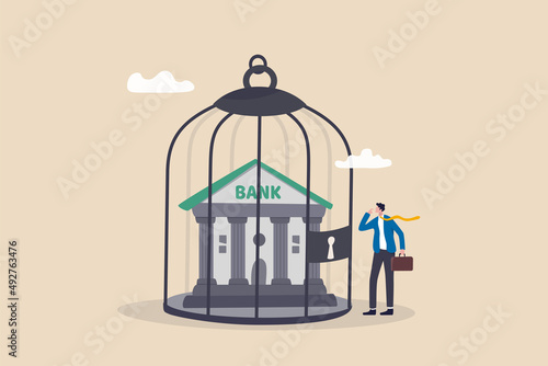 Financial sanction disconnect from SWIFT international money transfer, lockdown bank transaction against Russian war concept, businessman look at bank building locked inside bird cage.