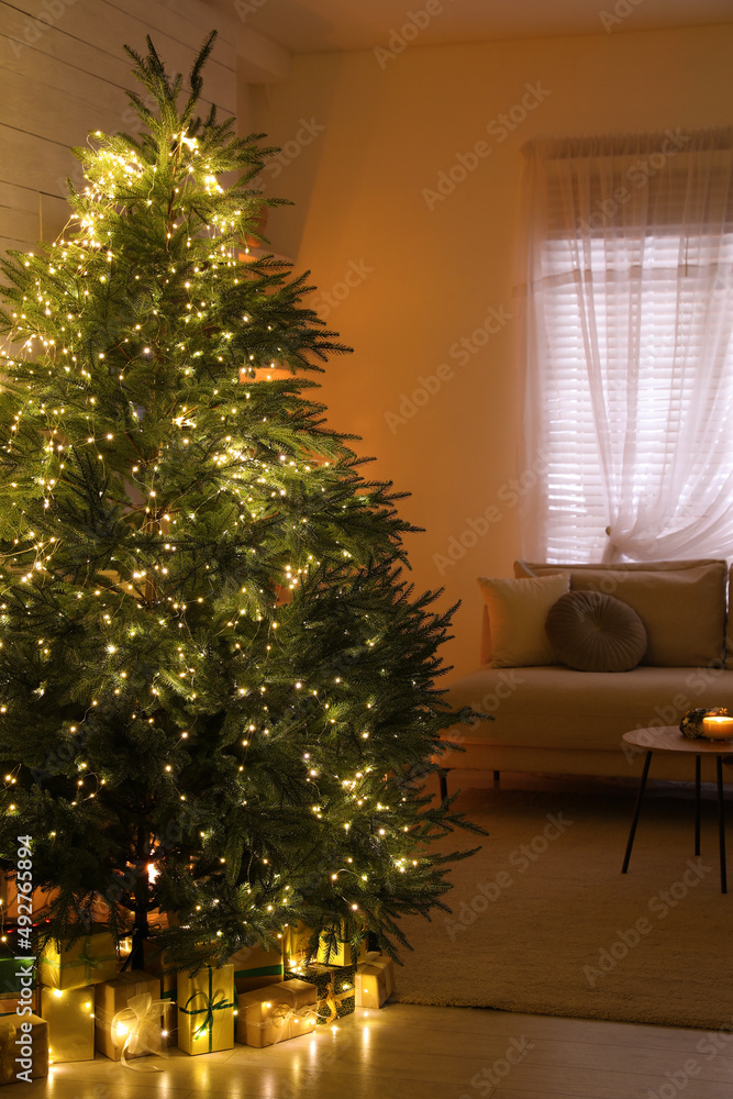 Stylish living room interior with beautiful Christmas tree