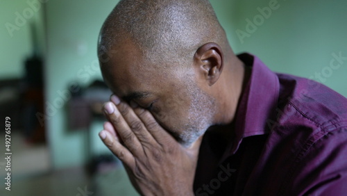 A preoccupied person an African senior man having despair and anxiety