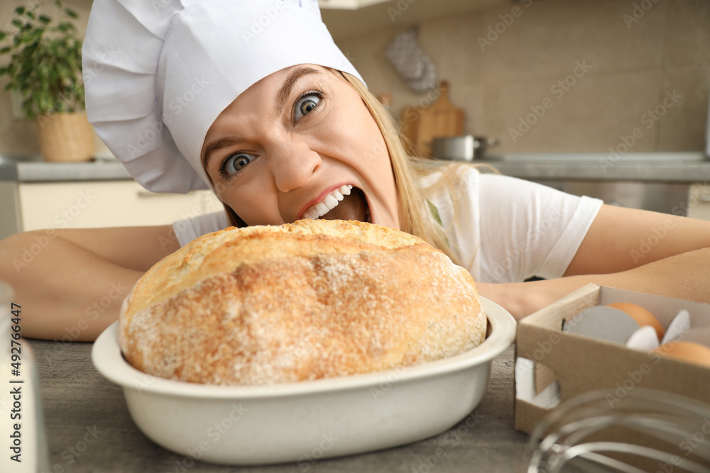 Young attractive chef woman wants to eat bread Young attractive chef woman wants to eat bread