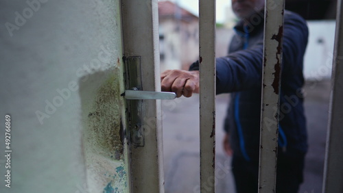 A Brazilian man closing front door going outside in the street person closes entrance for security