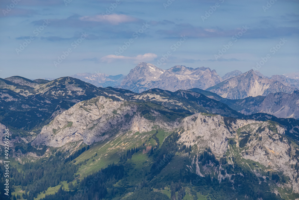 Panoramic view from Messnerin on Hochtor and alpine mountain chains in Styria, Austria, Hochschwab region. Hills overgrown with bushes, higher parts rocky. Summer day. Hiking in Alps, Tragoess
