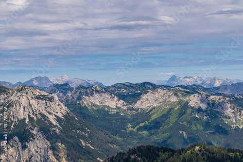 Panoramic view from Messnerin on the alpine mountain chains in Styria  Austria  Hochschwab region. Hills overgrown with small bushes  higher parts rocky and bare. Summer day. Hiking in Alps  Tragoess