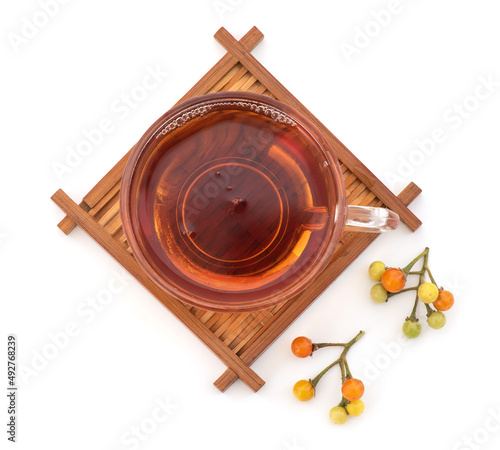 Brinjal or Solanum indicum and tea isolated on white background.top view,flat lay.