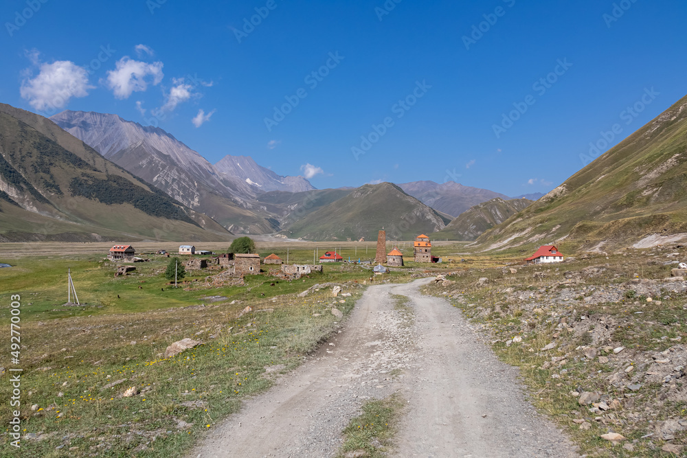 A hiking trail in the Truso Valley leading to the Ketrisi Village in Kazbegi District, Mtskheta in the Greater Caucasus Mountains, Georgia. A mountain road leading to an abandonned village.Landscape