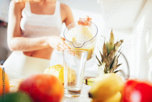 pouring fresh fruit smoothies into a glass. Peach, banana, apple. Close-up.Healthy food.