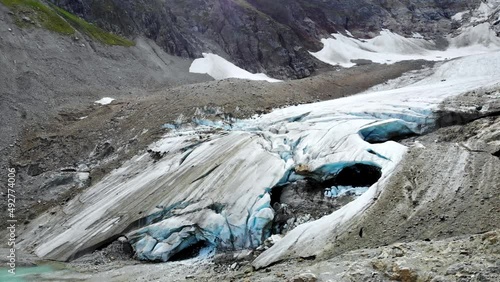 Aerial flyover over the end of Stein glacier with a view birds-eye  view of the crevasses at Sustenpass, Switzerland photo