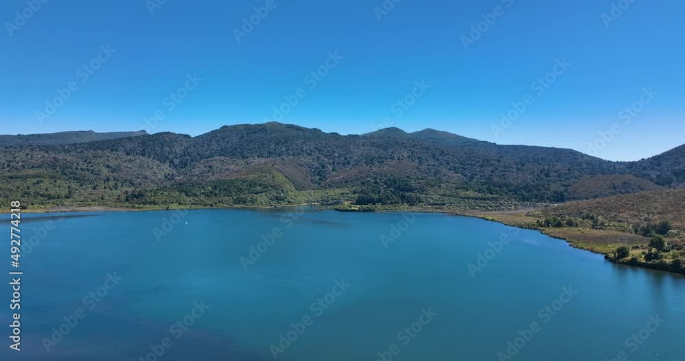 Flight over perfect blue lake and ideal blue Summer day - New Zealand Flight over perfect blue lake and ideal blue Summer day - New Zealand