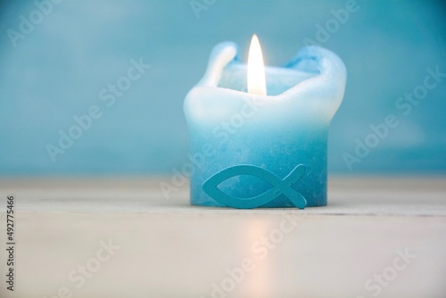 Candle with fish as a symbo...