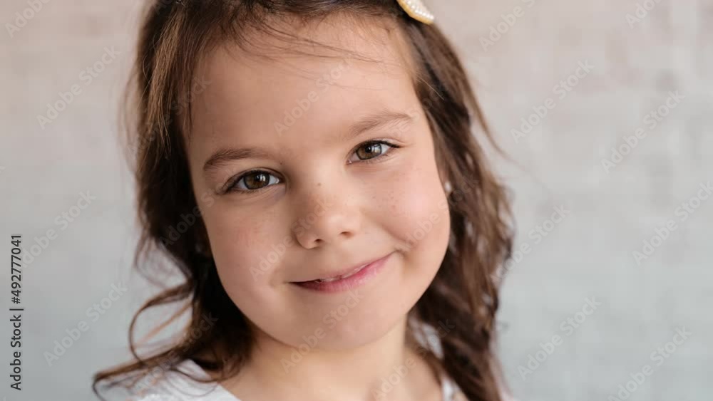 Happy little girl grin and looking at camera Happy little girl grin and looking at camera