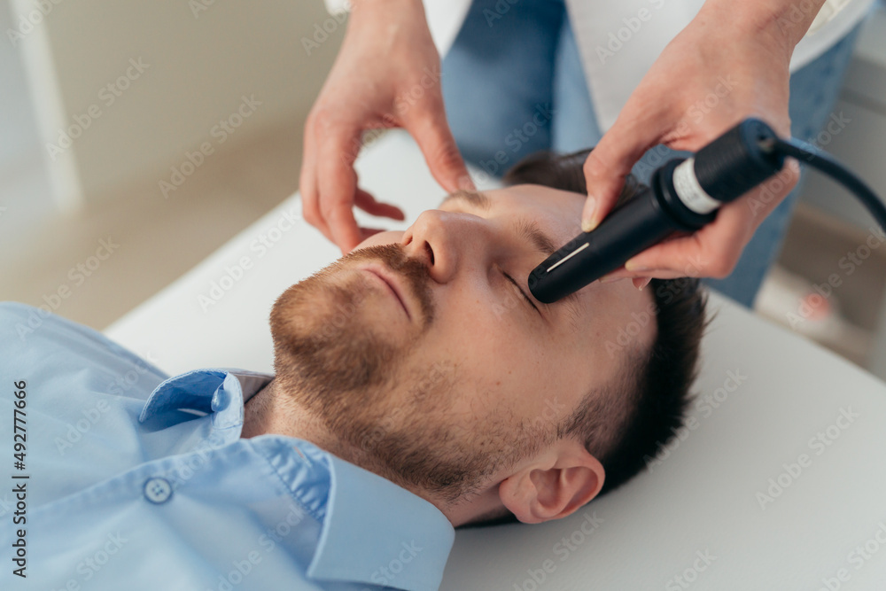 Fototapeta premium man has eyesight examination at clinic with ultrasound scanner
