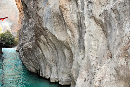 Canyon Saklikent in Turkish means "hidden city". Saklikent National Park in province of Mugla. Wild natural beauty. Emerald water of Yeshen River. Bottom of gorge. Fascinating canyon rocks.