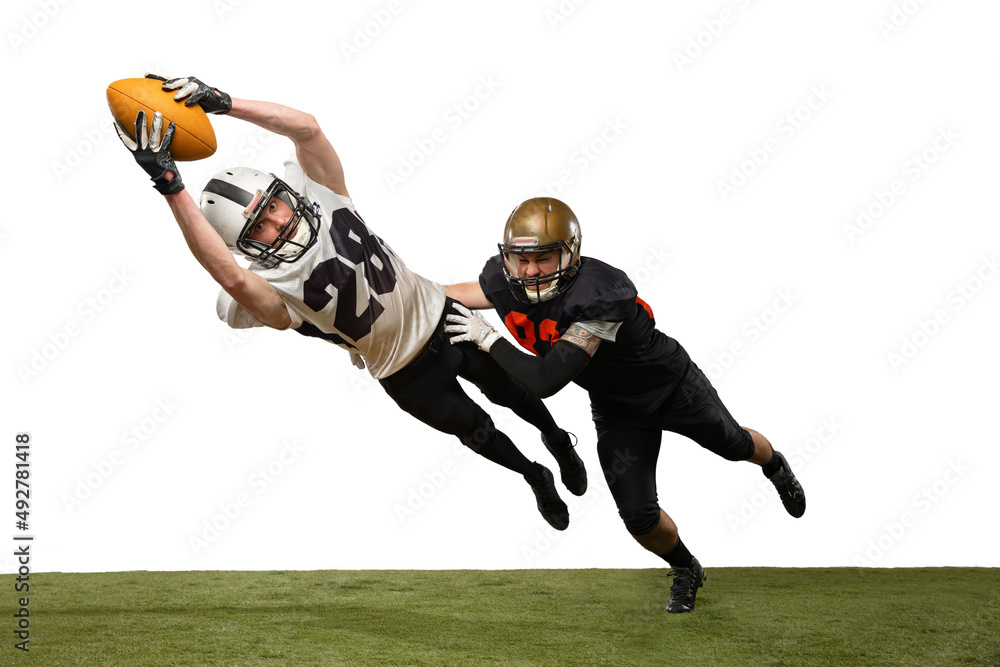 Two male american football players playing during sport match on grass flooring isolated on white background. Concept of sport, challenges, goals, strength. Poster, banner for ad